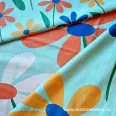   Nagy multicoloured flowers turquoise green on a background cotton percale