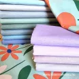   Small multicoloured flowers turquoise green on a background cotton percale